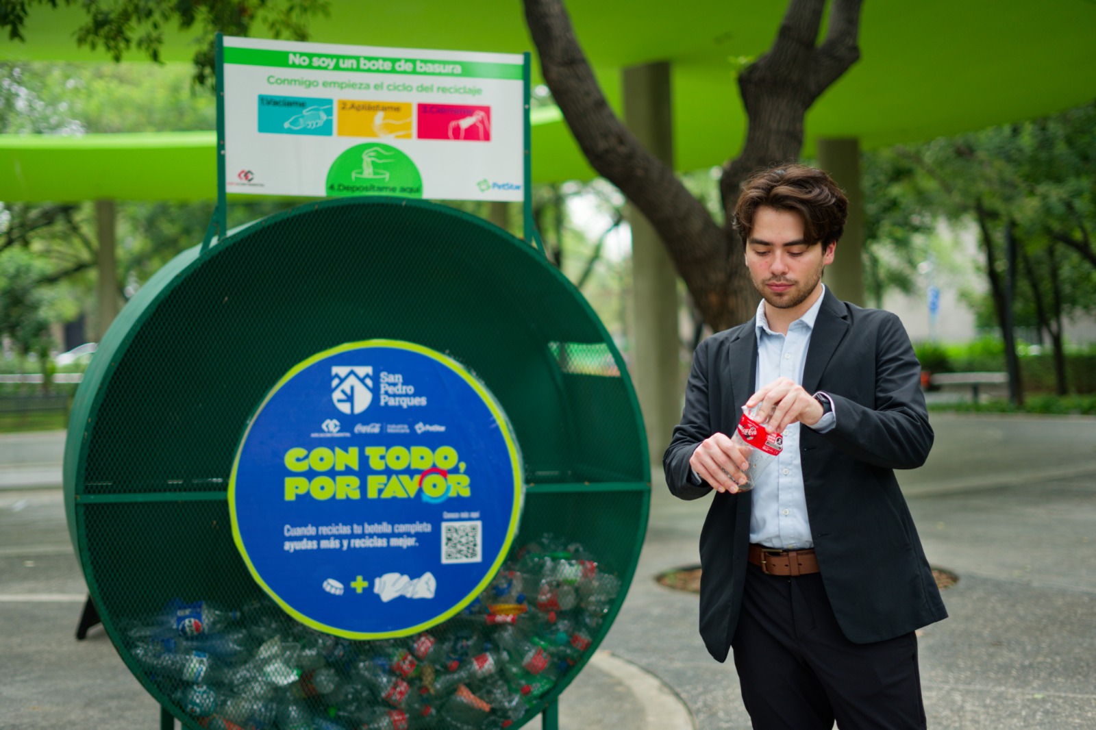 Joven depositando su botella en el contenedor Con Todo Por Favor